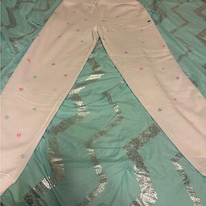 Champion Girls’ White Sweatpants with Multicolor Champion logo in pastel colors.